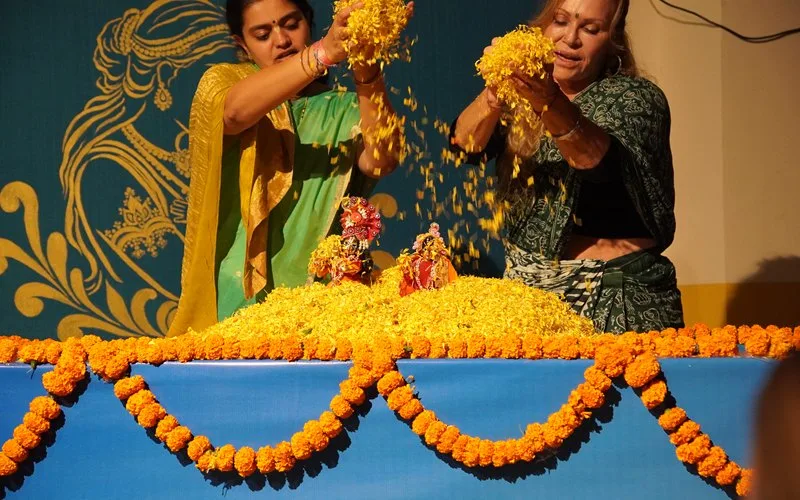 A festival float covered in marigolds and smiles