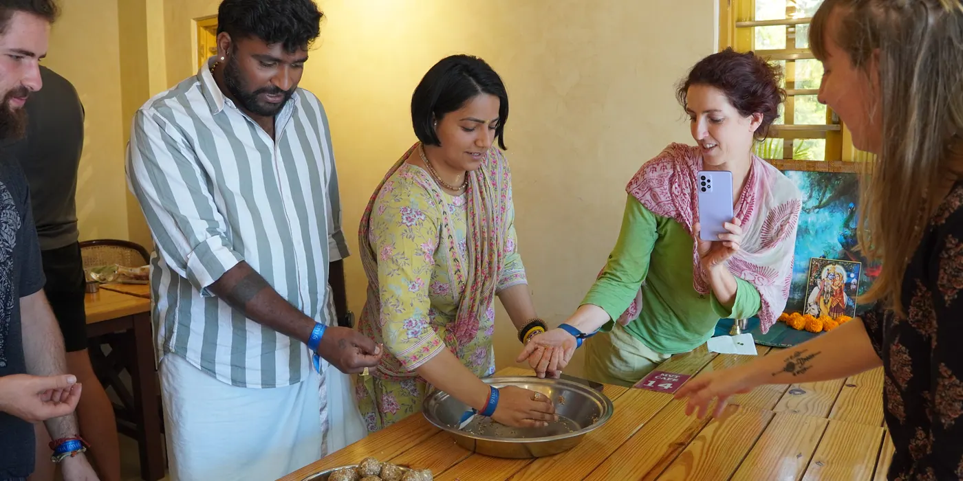 Preparing prasadam sweets together in a cooking workshop