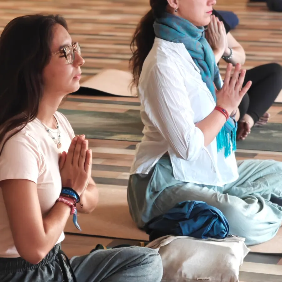 Hands folded in prayer during morning practice
