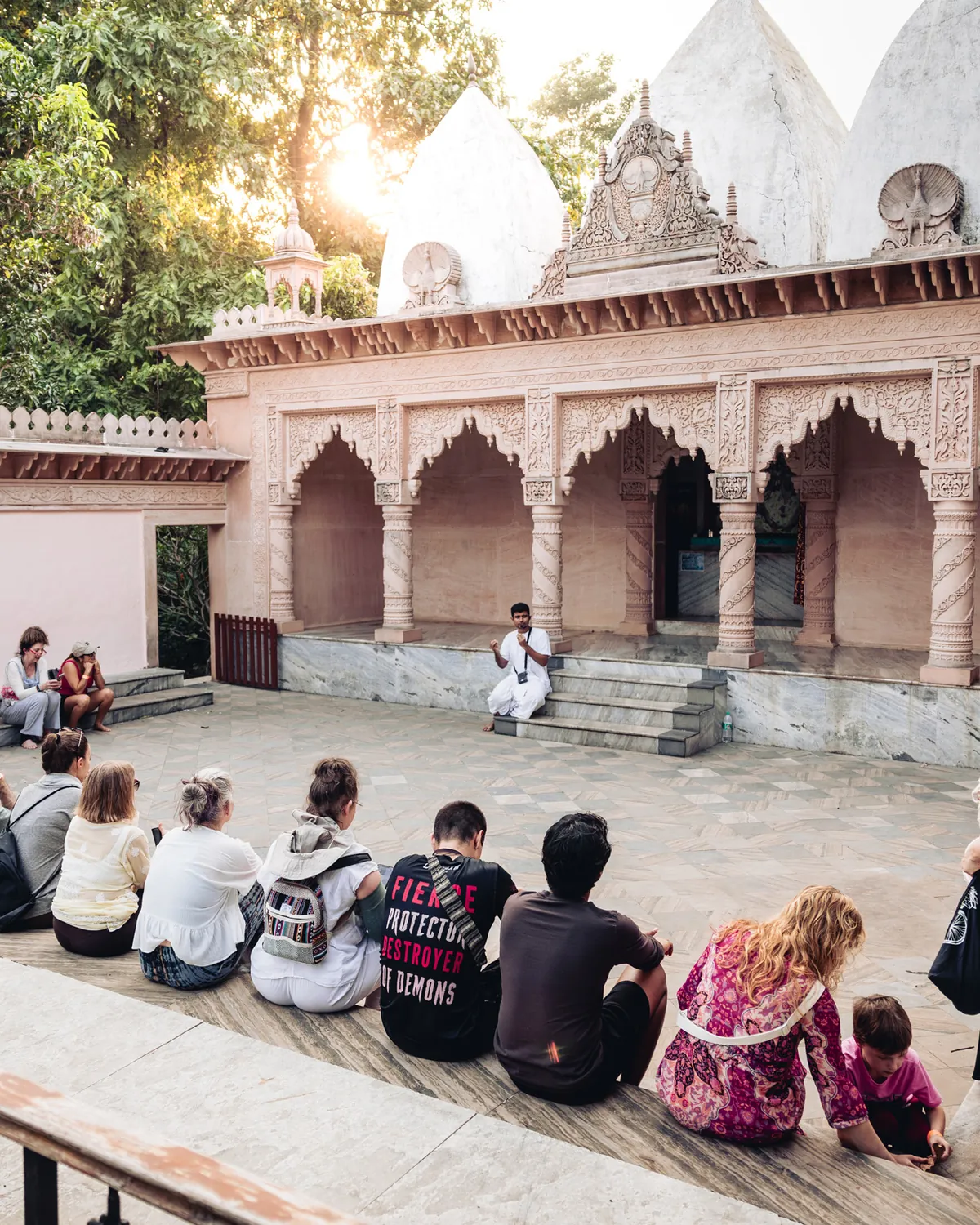 Participants seated together in the temple courtyard at Govardhan Eco Village